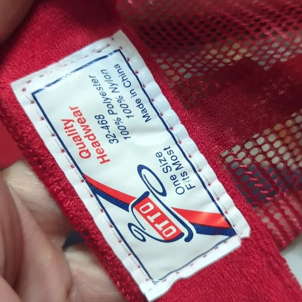red and white trucker hat featuring text that says 